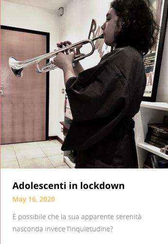 long-haired teenager boy in kimono playing the trumpet in apartment